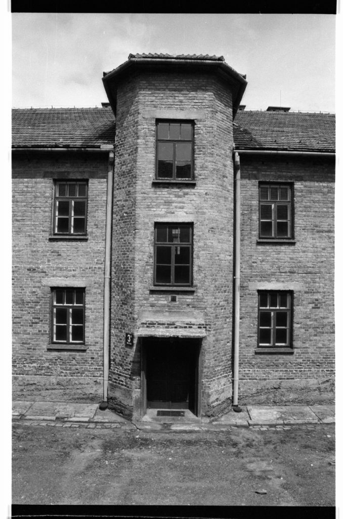 B/W photo of brick building. Building appears to be three stores. Nikon D70 Film Camera 2004 - Negative Scan from Nikon COOLSCAN V ED 2008