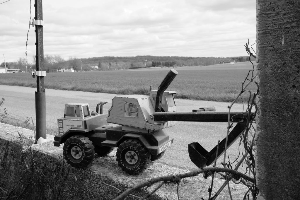 B/W photo of a forgotten Tonka Excavator left behind. April 2021 FujiFilm X-T20